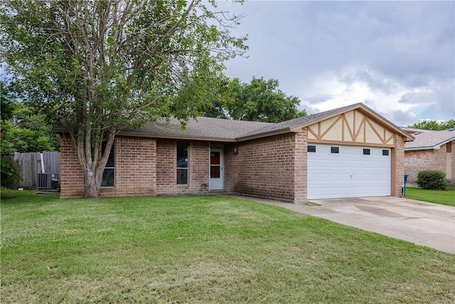 view of front of house featuring a garage, central AC unit, and a front yard