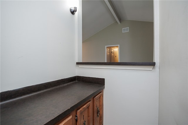 bathroom with vanity and lofted ceiling with beams