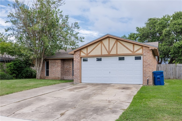 view of front of property with a garage and a front lawn