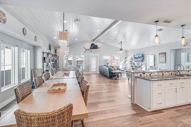 dining space featuring wood ceiling, ceiling fan, sink, lofted ceiling with beams, and light hardwood / wood-style flooring