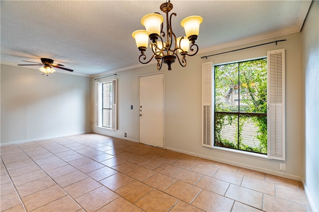 tiled spare room featuring ceiling fan with notable chandelier, plenty of natural light, a textured ceiling, and ornamental molding