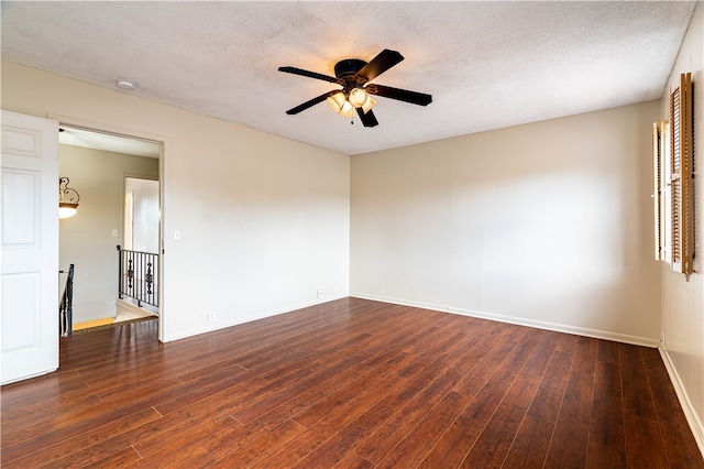 spare room with ceiling fan, dark hardwood / wood-style floors, and a textured ceiling