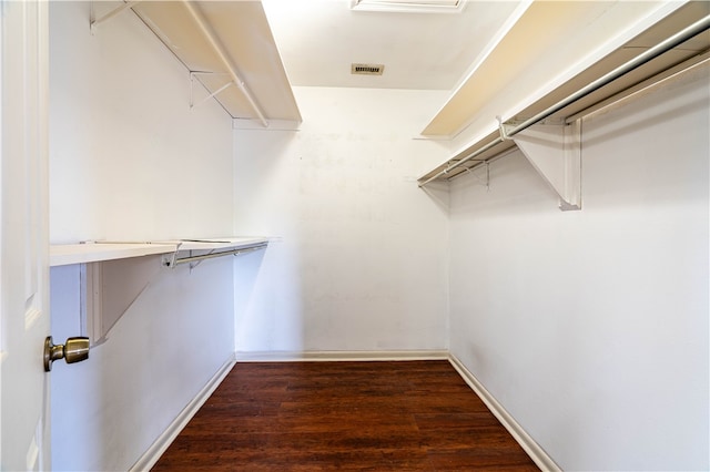 spacious closet with dark wood-type flooring