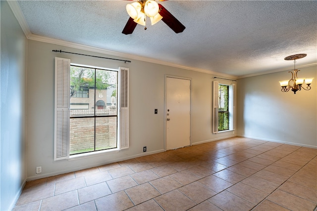 spare room with ceiling fan with notable chandelier, a textured ceiling, light tile patterned floors, and ornamental molding