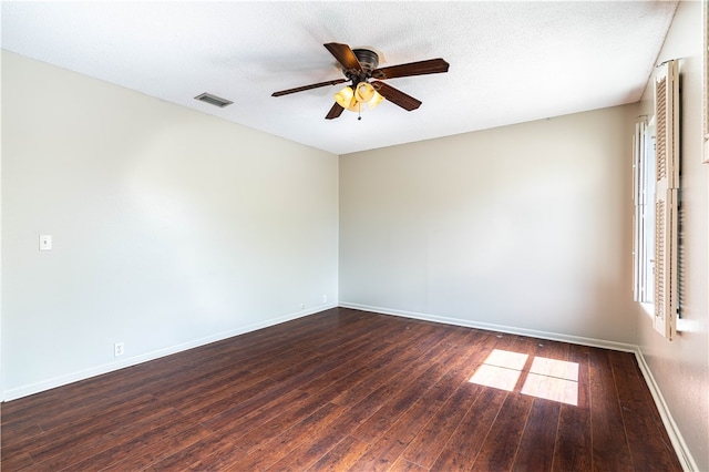 spare room featuring ceiling fan, dark hardwood / wood-style floors, and a textured ceiling