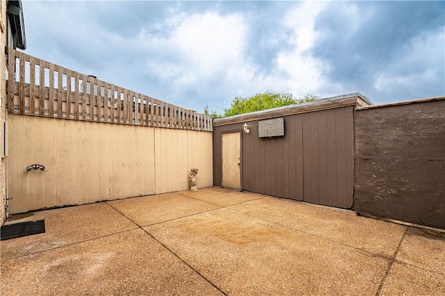 view of patio with a storage shed