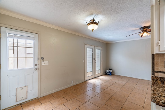 foyer featuring ornamental molding, french doors, a textured ceiling, and ceiling fan