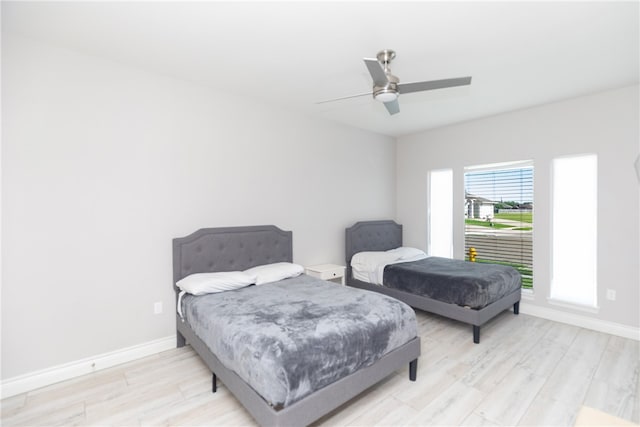 bedroom with ceiling fan and light hardwood / wood-style flooring