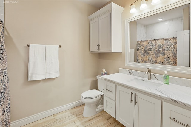 bathroom with hardwood / wood-style floors, vanity, toilet, and a shower with curtain