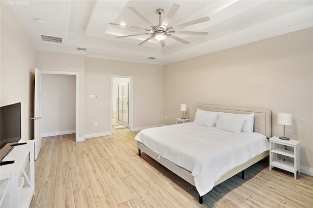 bedroom featuring light hardwood / wood-style floors, ceiling fan, crown molding, and a tray ceiling