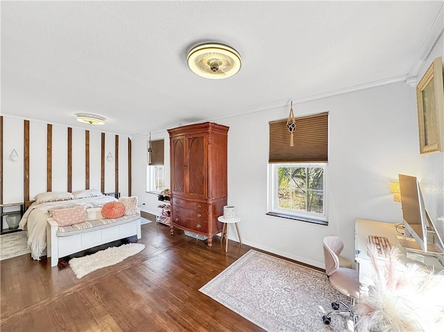 bedroom with dark wood-type flooring and baseboards