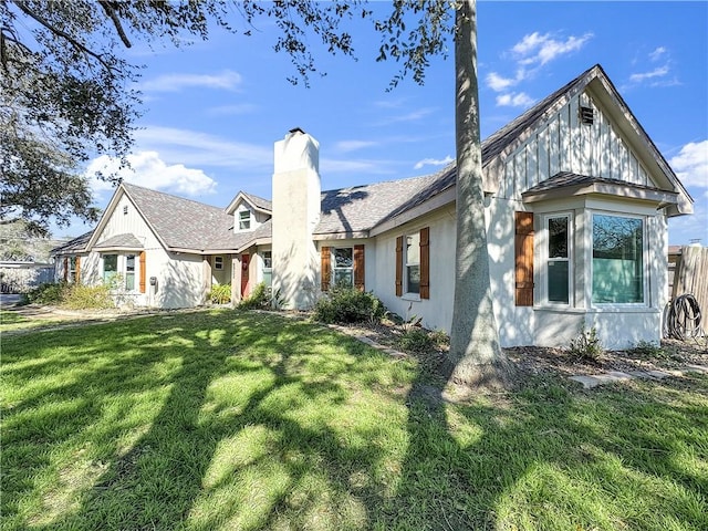 view of front of property with a chimney and a front yard