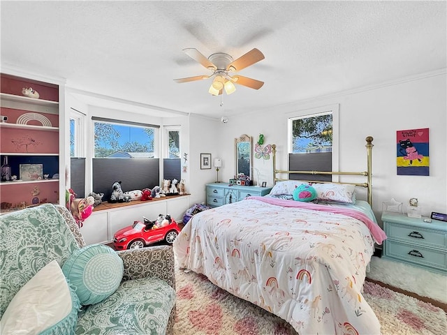 bedroom with carpet floors, ceiling fan, ornamental molding, and a textured ceiling