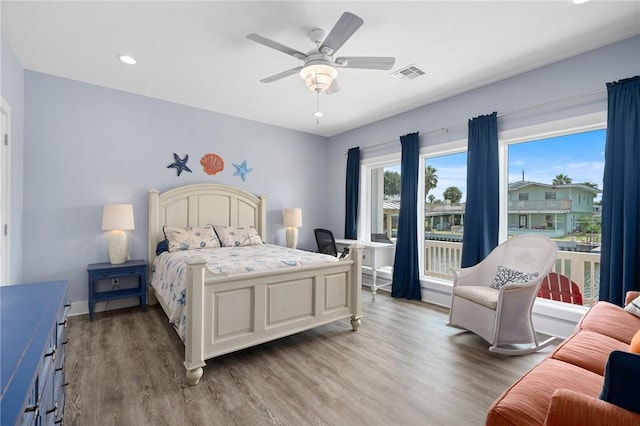 bedroom with ceiling fan and light hardwood / wood-style floors