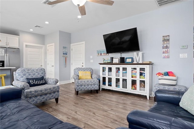 living room featuring hardwood / wood-style flooring and ceiling fan