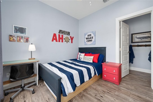 bedroom with hardwood / wood-style floors