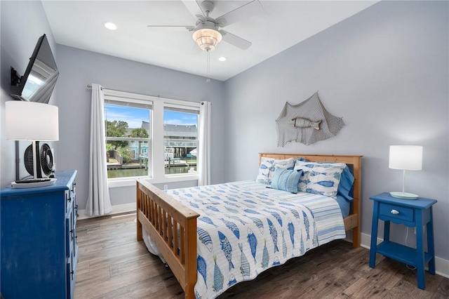 bedroom featuring ceiling fan and dark hardwood / wood-style flooring