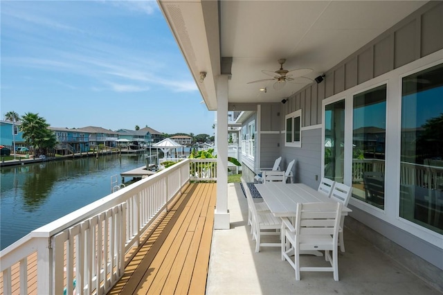 balcony with a water view and ceiling fan