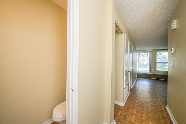 corridor featuring a textured ceiling