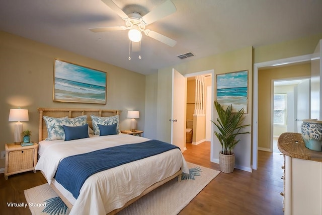 bedroom with dark hardwood / wood-style flooring and ceiling fan