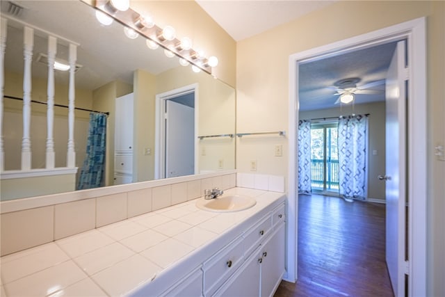 bathroom with vanity, hardwood / wood-style flooring, and ceiling fan