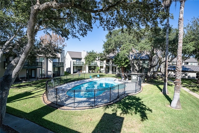 view of swimming pool with a lawn