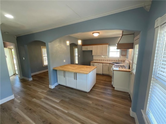 3662 Monterrey, Corpus Christi, TX 78411 - kitchen featuring wood counters, white dishwasher, a peninsula, arched walkways, and ornamental molding