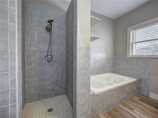 bathroom featuring toilet, a jetted tub, plenty of natural light, and wood finished floors