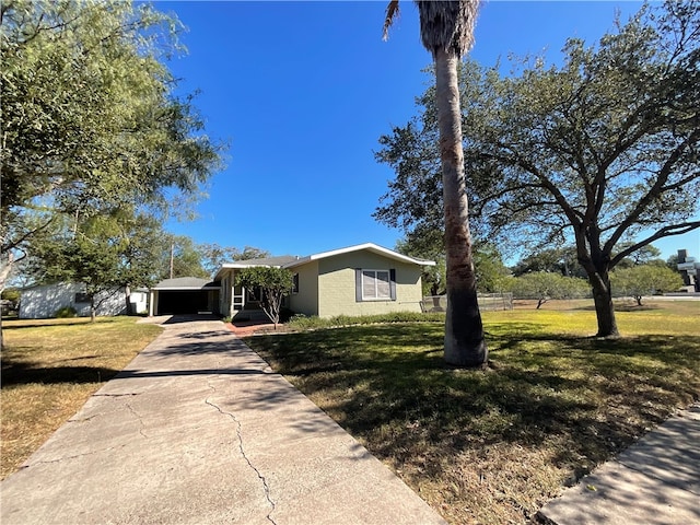 ranch-style home with a garage and a front yard