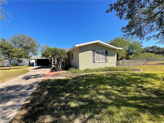 view of property exterior with a carport, concrete block siding, driveway, and a lawn