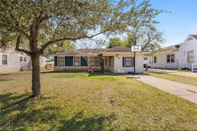 ranch-style home with a front yard and stone siding