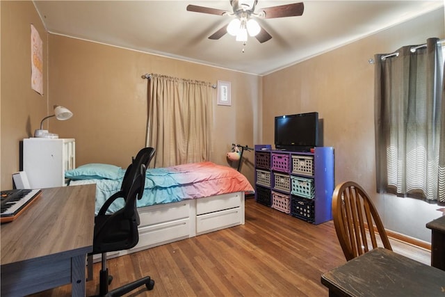 bedroom featuring ceiling fan and wood finished floors