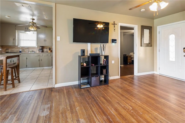 entrance foyer with light wood-style flooring, visible vents, baseboards, and a ceiling fan