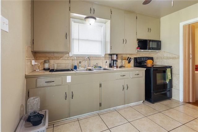 kitchen featuring light tile patterned floors, light countertops, ceiling fan, a sink, and black appliances