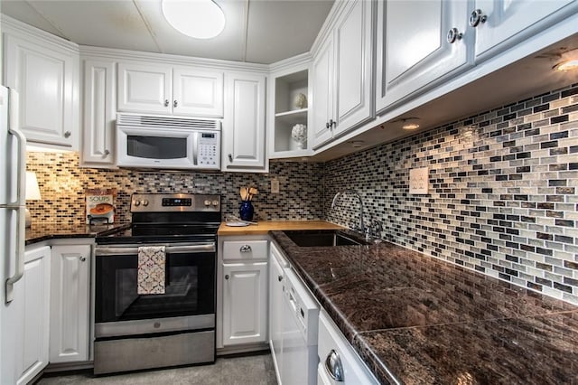 4600 Ocean Dr Unit 505, Corpus Christi, TX 78412 - kitchen featuring white appliances, white cabinets, backsplash, and butcher block counters