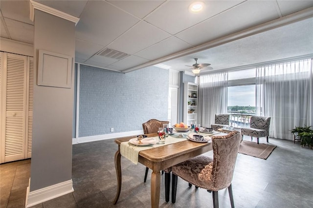 4600 Ocean Dr Unit 505, Corpus Christi, TX 78412 - dining space with brick wall, ceiling fan, and a paneled ceiling