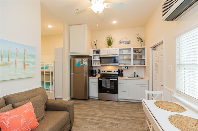 kitchen with white cabinetry, sink, light hardwood / wood-style floors, and stainless steel appliances