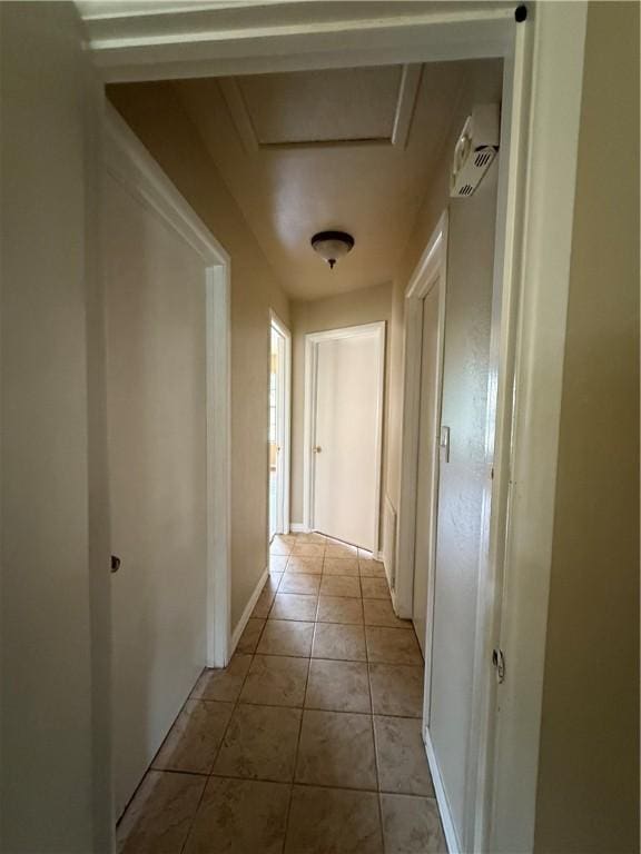 1005 Schallert Dr, Alice, TX 78332 - corridor with light tile patterned floors, attic access, and baseboards