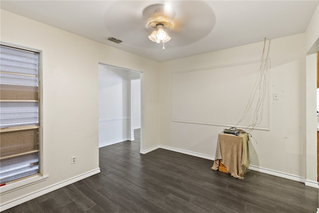 spare room with dark wood-type flooring and ceiling fan