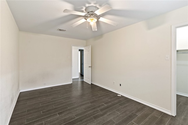 spare room featuring dark hardwood / wood-style flooring and ceiling fan