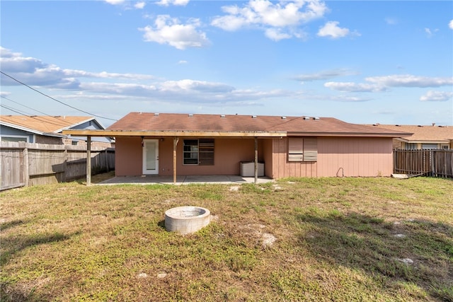 rear view of property featuring a patio and a lawn