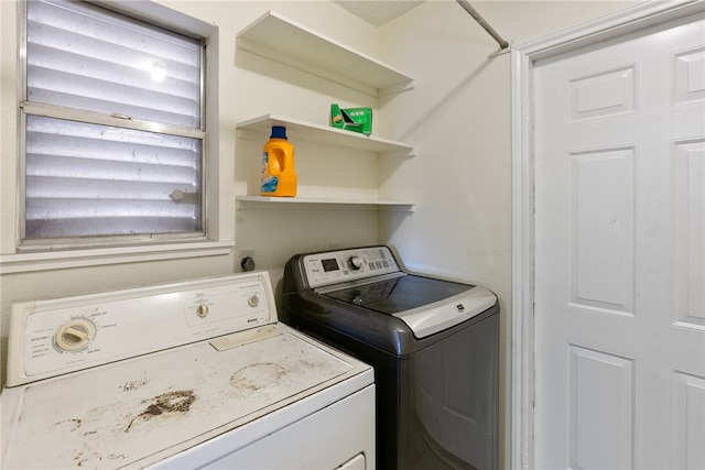 laundry room featuring washing machine and clothes dryer