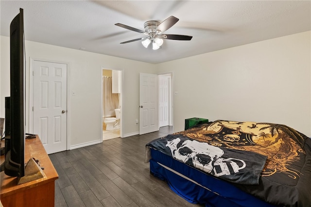 bedroom featuring dark wood-type flooring, ceiling fan, and connected bathroom