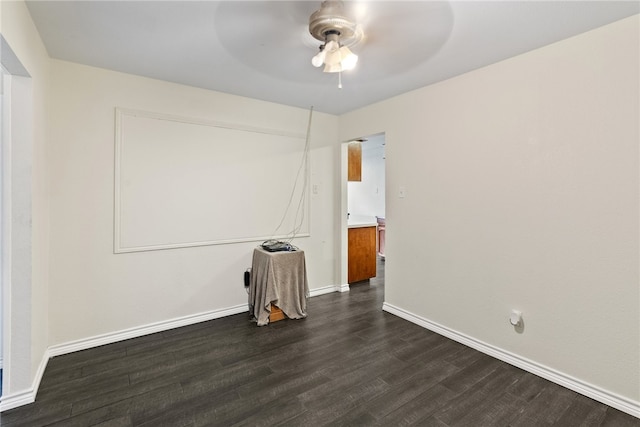 empty room with dark wood-type flooring and ceiling fan