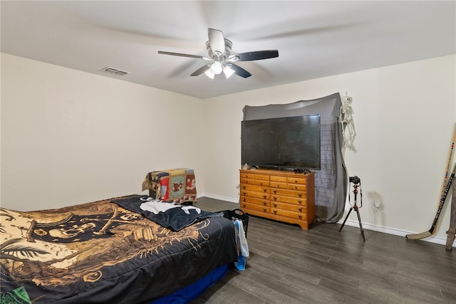 bedroom with ceiling fan and dark hardwood / wood-style floors