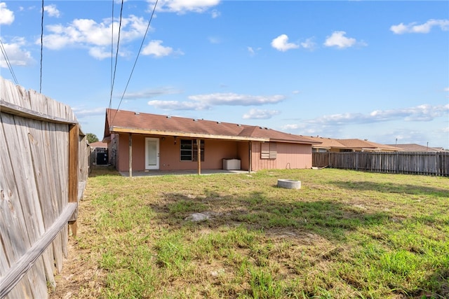 rear view of house with a patio and a yard