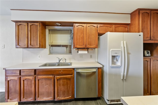 kitchen featuring dishwasher, sink, dark hardwood / wood-style floors, and white refrigerator with ice dispenser