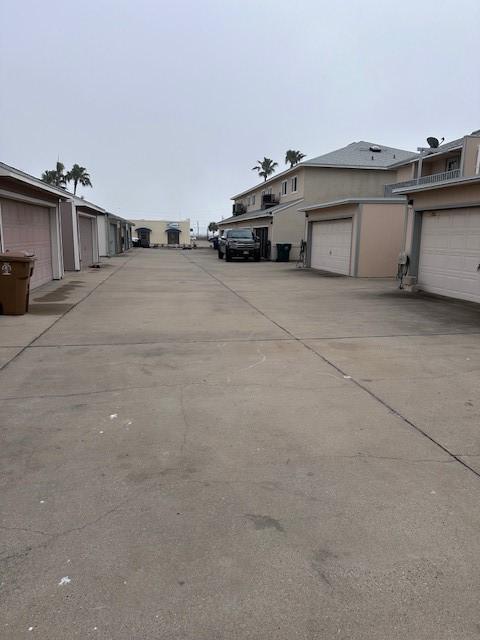 view of road featuring community garages