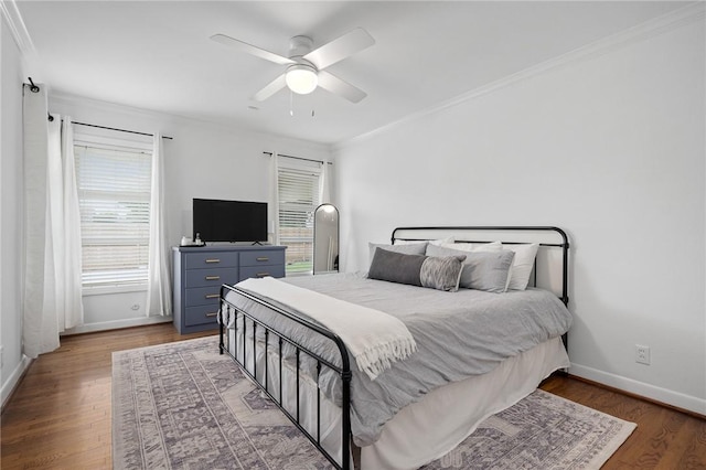 bedroom with ceiling fan, dark hardwood / wood-style flooring, and ornamental molding