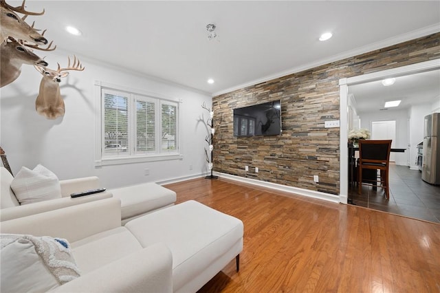 living room featuring hardwood / wood-style floors and ornamental molding